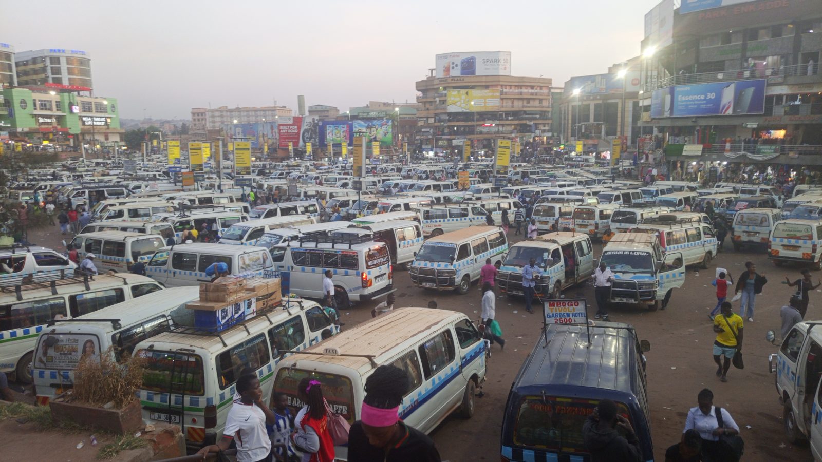 Taxis and commuters at Kampala's Old Taxi Park showing urban congestion.
