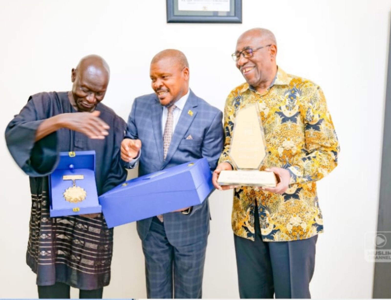 Uganda Ambassador Ssemuddu Rashid presents International Excellence Award during a meeting with former Prime Minister Ruhakana Rugunda.