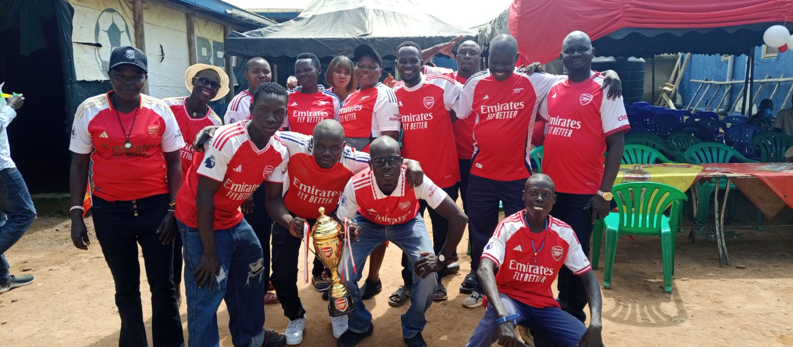 Arsenal fans from Onduparaka dressed in red and white during an EPL trophy celebration in Arua City.