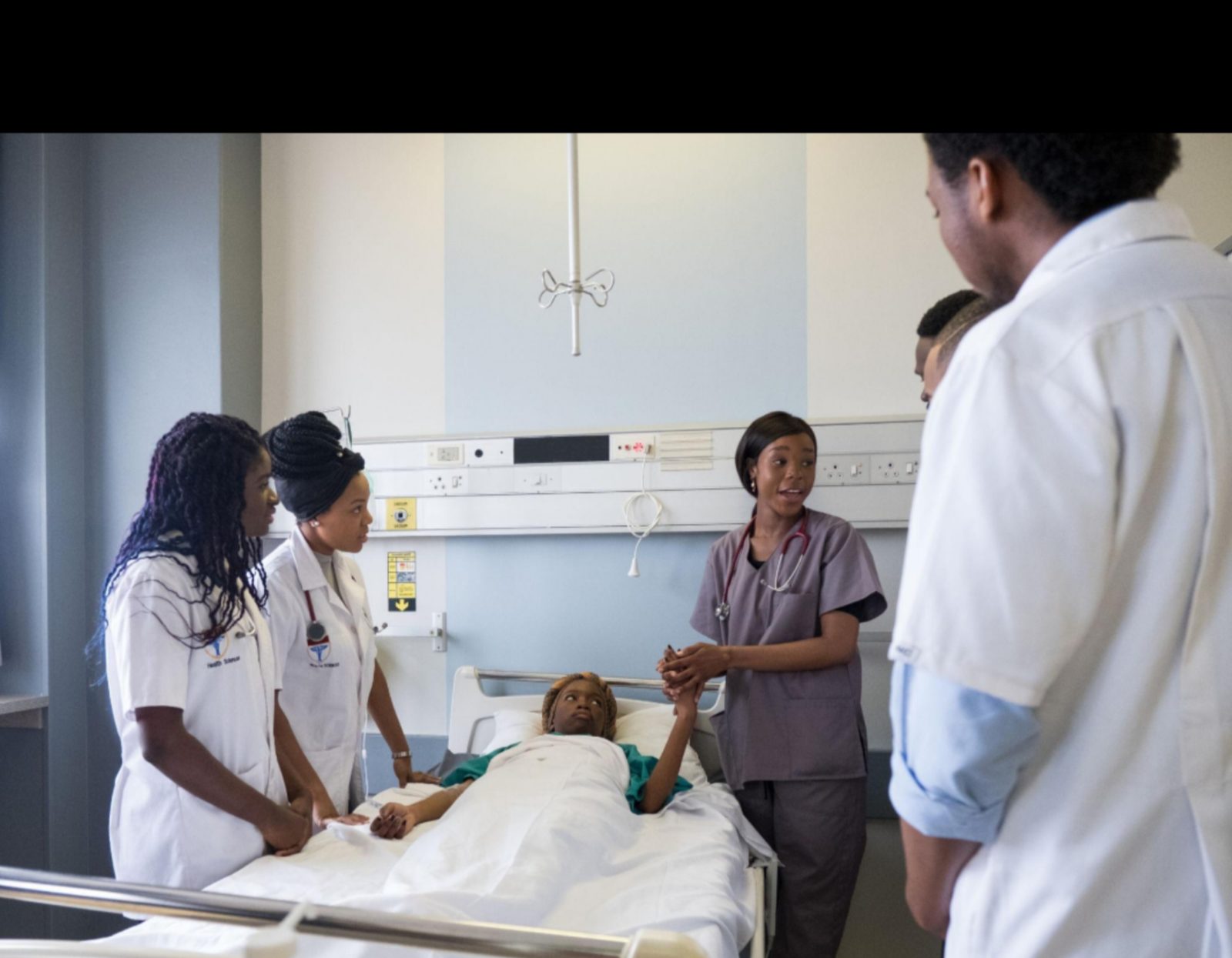 African doctors and nurses attending to patients in a busy hospital as the continent faces a growing health workforce shortage.