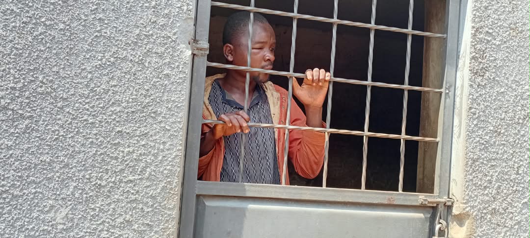 Suspect Byasali Rogers in police custody at Mbulamuti Police Station in Kamuli District.