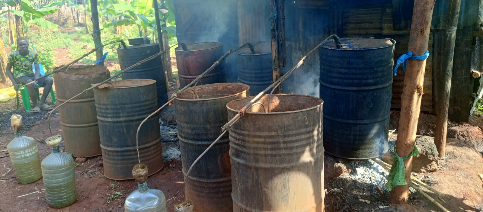 Women in Porota, Kakira, demonstrate the traditional process of distilling molasses into locally produced spirit.
