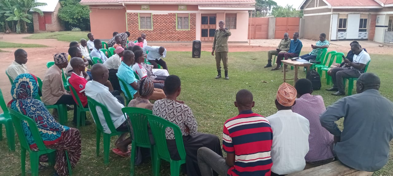 Police officer Ibrahim Batamye addresses residents during a community meeting on protecting widows and orphans from land and property eviction in Nasuuti, Iganga District.